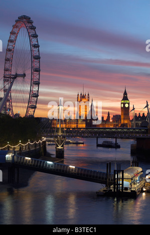 England, London, London Eye, Big Ben und den Houses of Parliament, über die Themse von Waterloo Bridge bei Sonnenuntergang gesehen. Hungerford Bridge steht im Vordergrund. Stockfoto