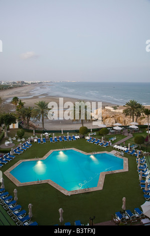 Oman, Maskat, Qurm. Dawn Ansicht von Crowne Plaza Hotel-Pool und Qurm Beach Stockfoto