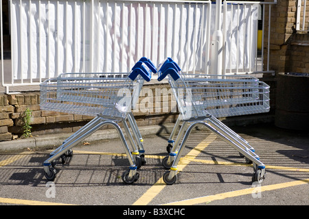 Vier Einkaufswagen einander abgewandten. Setzen Sie in ein Muster. Stockfoto