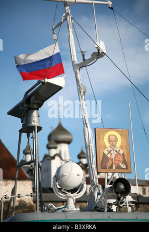 Russische Flagge und die Ikone des Heiligen Nikolaus auf dem Pilger Schiff vor dem Solovetsky Kloster im Weißen Meer, Russland Stockfoto