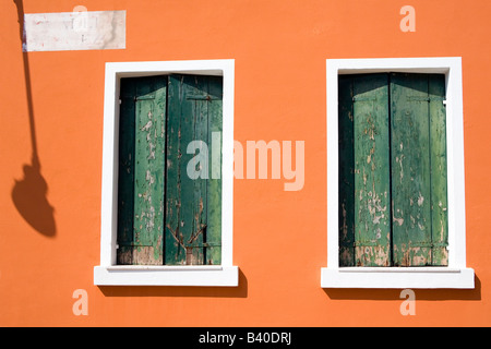 Grüne Fensterläden in einem alten orange bemalten Gebäude Venedig Italien Stockfoto