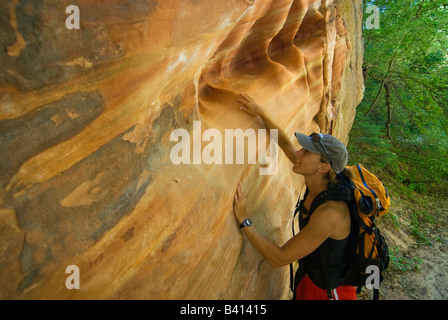 USA, Utah, Zion Park.  Eine weibliche Wanderer untersucht die Muster in der Wand des Hidden Canyon.  (MR) Stockfoto