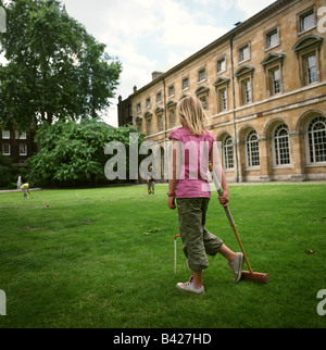 Ein junges Mädchen spielt Krocket auf dem Rasen des College Garden, Westminster Abbey. Stockfoto