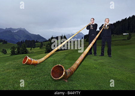 Alphorn-Spieler in den Bergen Stockfoto