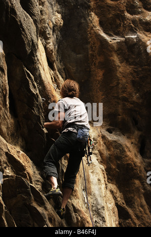 Kletterer, die er seinen Weg auf einem riesigen senkrechten Felswand in Nepal Stockfoto