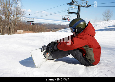 Boy am Ski-Hügel mit Snowboard, Blue Mountain, Collingwood, Ontario, Kanada Stockfoto