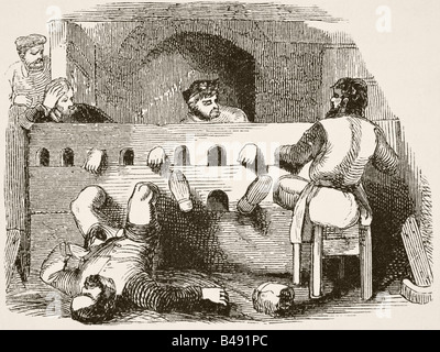 Gefangene in den Beständen gesperrt Stockfoto