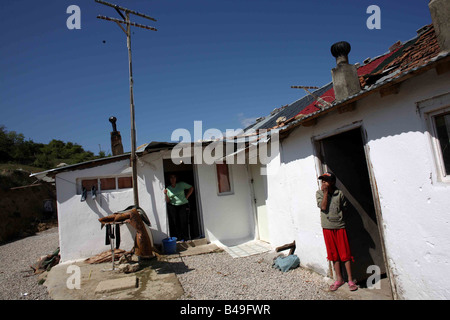 Eine Frau und ein Mädchen stehen in den Türen Roma-Zigeuner-Häuser in Korca, Albanien Stockfoto