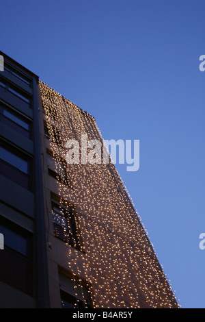 hell hängen Lichterketten am Gebäude in der Stadt Stockfoto