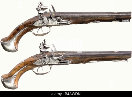 Ein Paar doppelbartige Flintlock-Pistolen, Andre à Nancy, ca. 1740/50. Runde, glatte Bohrfässer im Kaliber 13,5 mm. Goldeingelegte Schriftrollendekoration (teilweise getragen) auf den Fässern. Die mit der Signatur "Andre à Nancy" gravierten Schlossplatten. Eine Pan-Abdeckung ist ein guter Ersatz. Leicht geschnitzte Walnussbestände mit schöner Figur und silbernem Drahteinlage. Silbernes Mobiliar mit Reliefverzierung (Markenzeichen) und gravierte Dekoration. Die Pommels haben reliefende groteske Maskenblaken. Geschwärzte Walmstangen mit eisernen Spitzen und Spitzen. Länge je 37,5 cm historisch, histor, Stockfoto