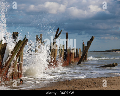 Meer Abwehr gebogen und durch Wellengang verdreht. Durch die Felsen am happisburgh Norfolk England geschützt Stockfoto