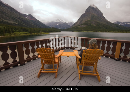 Frau, die Aussicht auf dem Deck der Many Glacier Hotel in Glacier Nationalpark Stockfoto