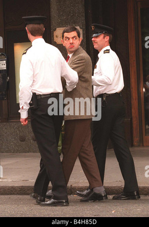 Rowan Atkinson Schauspieler als Mr. Bean Dreharbeiten bei Harrods, von Polizisten verhaftet Stockfoto