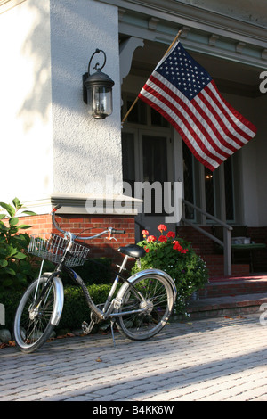 Fahrrad und amerikanische Flagge vor dem Stone Cliff Manor Mackinaw Island Michigan USA geparkt, von Carol Dembinsky/Dembinsky Photo Assoc