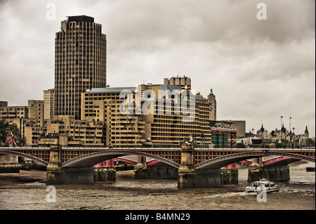 Blackfriars Eisenbahnbrücke über die Themse mit Sea Containers Hotel und Gallery Tower in der Ferne an einem grauen Wintertag. Stockfoto