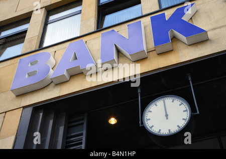 BANK-Zeichen auf ein Gebäude und eine Anzeige 12:00 Uhr Stockfoto