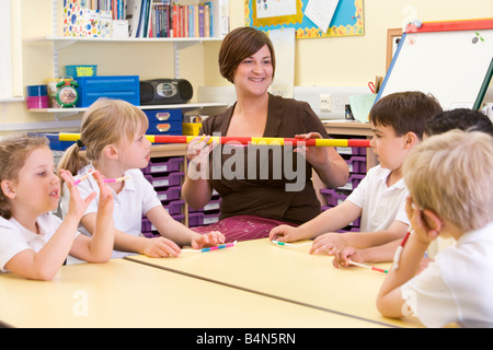 Lehrer und Schüler in Mathematik Klasse mit Messlatte Stockfoto