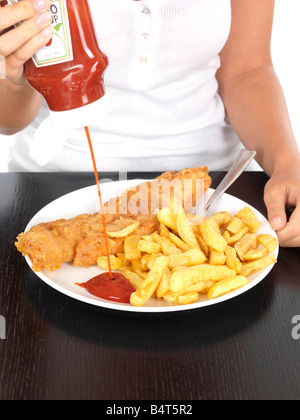 Junge Frau, Ketchup auf Fish &amp; Chips-Modell veröffentlicht Stockfoto