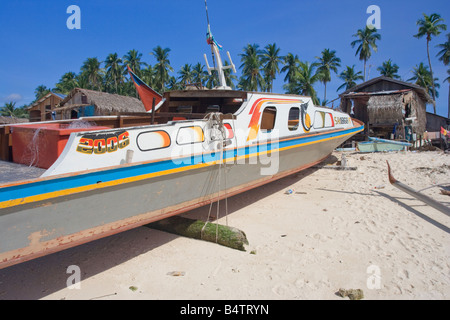 Ein Fischerboot am Strand vor einem Fischerdorf auf der Insel Mabul Nr. Semporna Sabah Malaysia hochgezogen Stockfoto