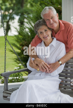 Älteres Paar, sitzen auf der Veranda-Schaukel Stockfoto