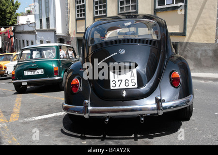 Schwarze VW Käfer parkte neben einem Mini Cooper auf einem Hügel bei einer Oldtimer-Show in Guia de Isora-Teneriffa-Kanarische Inseln-Spanien Stockfoto