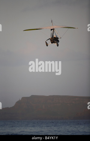 Microlite fliegen über das Meer am Strand von weißen Felsen in Portrush bei Sonnenuntergang Northern ireland Stockfoto