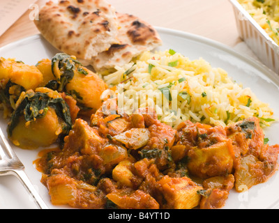 Chicken Bhoona, Sag Aloo, Pilau Reis und Naan-Brot Stockfoto