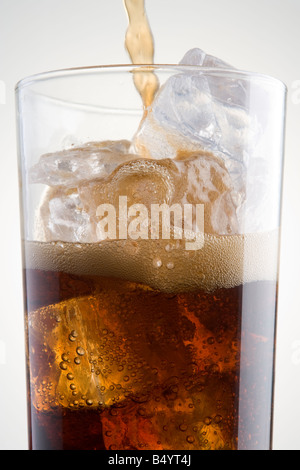 Cola in einem Glas aus Eis gießen Stockfoto