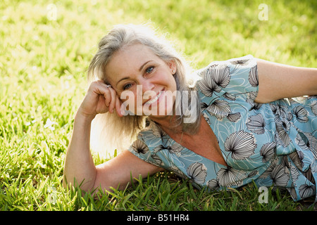 Porträt der Frau im Gras liegen Stockfoto