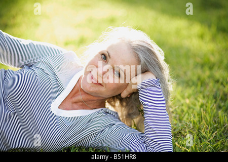 Porträt der Frau im Gras liegen Stockfoto