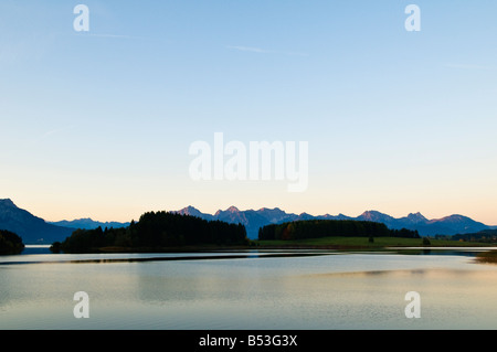 Forggensee-See in der Morgendämmerung mit Allgäuer Alpen Berge steigen in Ferne Bavaira, Deutschland Stockfoto