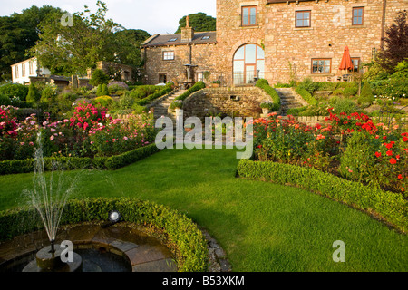 Brunnen im Garten Pool mit Rosenbeeten und hedging-box Stockfoto