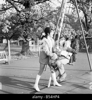 Familienfotos von Alan und Maureen Rothwell, mit Babys, Tody im Alter von 2 Jahren, und Ben im Alter von 16 Monaten, spielen auf der Schaukel und Rutschen bei ihrer örtlichen Spielplatz. ; November 1969; Z11219 Stockfoto