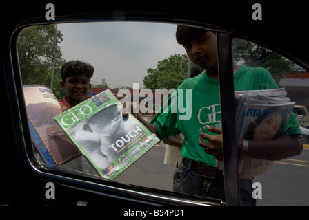 Indianerjunge Zeitschriften im Verkehr Marmeladen in Neu-Delhi zu verkaufen. Stockfoto