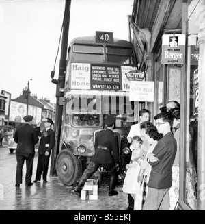 London Transport Funktionäre und Feuerwehrmänner inspizieren den Schaden nach einem Unfall an der Green Street, Upton Park. waren 2 Autos und ein Bus in eine Kollision verwickelt waren. Der Bus landete an der Vorderseite ein Geschäft. Juni 1960 M4349-004 Stockfoto