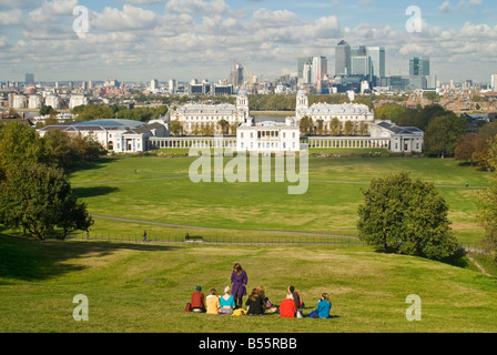 Horizontalen Weitwinkel von Touristen im Greenwich Park Hill genießen Sie die spektakuläre Aussicht über Greenwich Park in Richtung Canary Wharf. Stockfoto