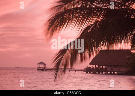 Menschen in der Beachbar in der Nähe von den Liegeplätzen am Sonnenuntergang, Placencia, Belize, Mittelamerika Stockfoto