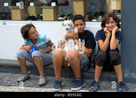 Drei Jungs sitzen auf Schritt mit Hund Stockfoto