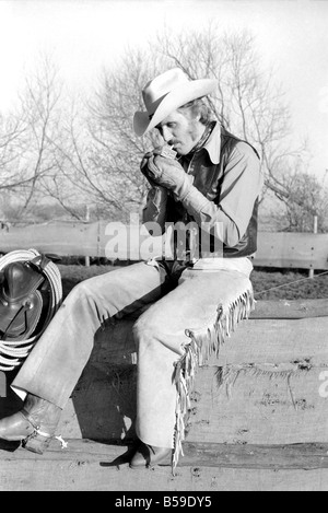 Bauer Bill Frith Appledore, Kent, in Cowboy Kleid und Sporen, mit seinem American Quarter Horse Hengst Jack Bouncer zeigt ihr Tempo bei "schneiden eine Steuern" in den Ring, die speziell auf seiner Farm gebaut. ; Februar 1975; 75-01160-006 Stockfoto