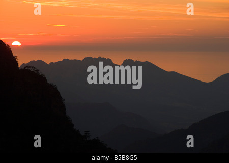 Von hoch oben in den Bergen Korsikas am Wegesrand GR20, Blick nach Westen, den Sonnenuntergang über dem Mittelmeer. Stockfoto