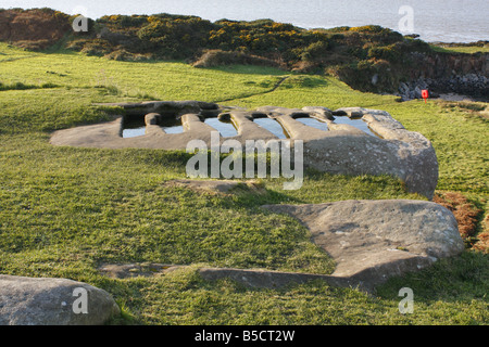 Frühen christlichen Felsen gehauene Gräber gefüllt mit Regenwasser auf einem Sandstein von St Patricks Kapelle Stockfoto