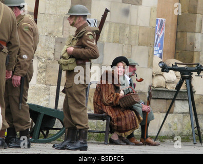 jährliche ww2 Kriegszeit Wochenende Pickering North Yorkshire, paar im Zeitraum Kleid am Bahnhof Bahnsteig mit britischen Soldaten Stockfoto