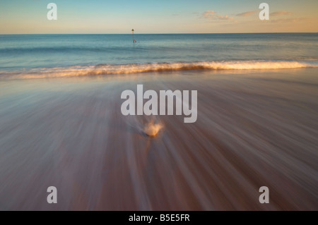 Welle, Rauschen heraus über Eisen Buhnen am Meer in Teignmouth, Devon UK Stockfoto