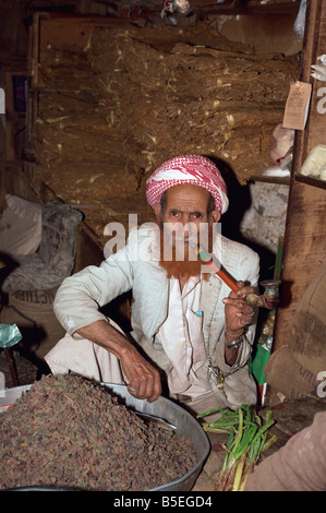 Porträt einer älteren Ladenbesitzers mit Henna gefärbten Bart, Rauchen einen Rohr, Djiblah, Jemen, Naher Osten Stockfoto