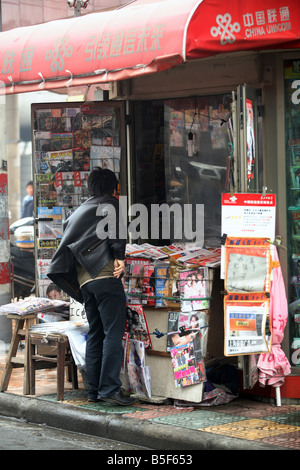 Mann an einem Kiosk in Shanghai, China Stockfoto