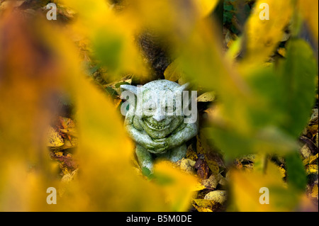 Groteske Gargoyle hässlich Autumn Leaves Großbritannien glänzen Gold braun grüne Grafik Saison feucht Stockfoto