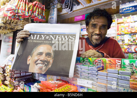 Ein Kiosk-Besitzer in New York City hält eine Zeitung kündigt historischen Präsidenten Barack Obamas Sieg im November 2008 Stockfoto