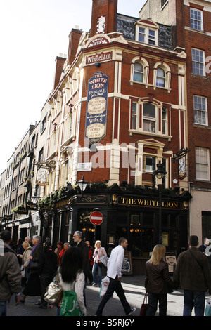 Menschen gehen auf der Straße in London vor pub Stockfoto