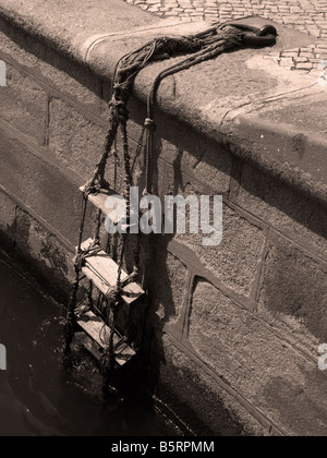 Strickleiter aus dem Boot, hausgemachte Einschiffung Punkt fixiert Hafenmauer festmachen Ring, Granit gebaut Landung Stahl, Stockfoto