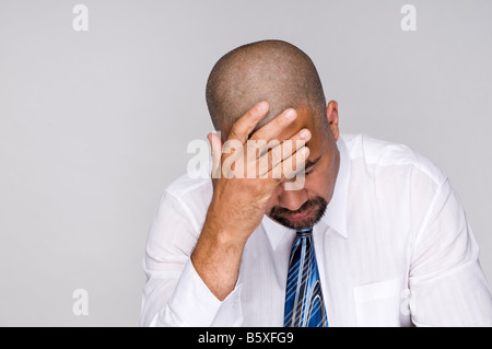 Deprimiert aus Arbeit Geschäftsmann hielt Kopf in Verzweiflung. Stockfoto